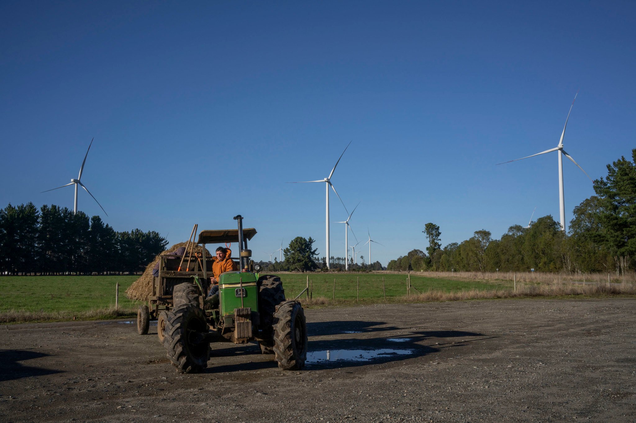 un tractor cerca de un parque eólico